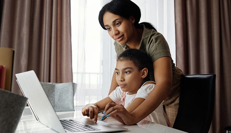 Parent and child online using laptop